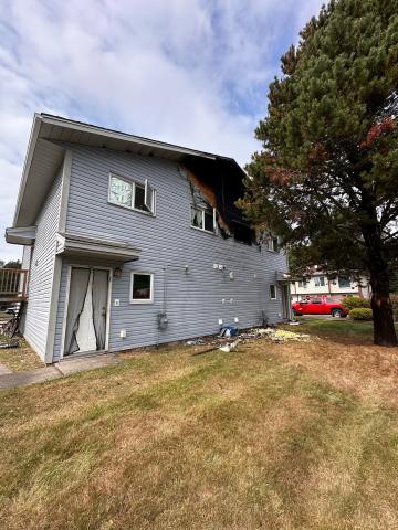 An exterior shot of a house with large scorch marks around the upper-storey bedroom where the fire occurred
