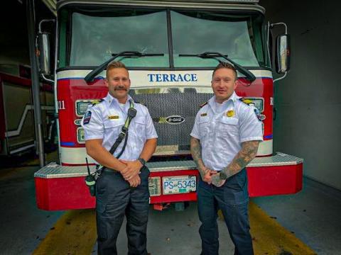 photo of Joel Brousson and Chad Cooper in front of fire truck