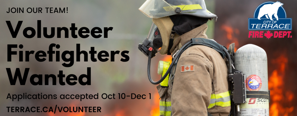 Volunteer Firefighters Wanted - photo of a firefighter standing in profile in front of flames and smoke